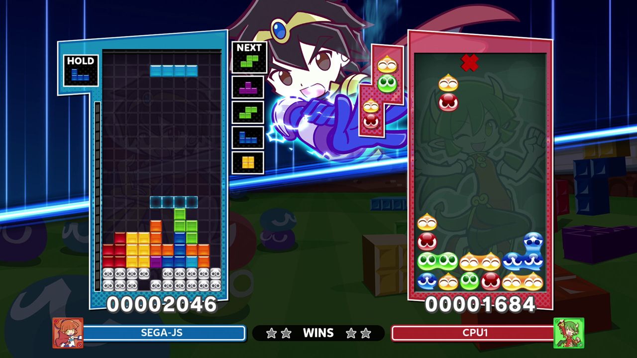 A Puyo Puyo Tetris 2 match: a Tetris board on the left against a board of Puyo blobs on the right, with a character leaping between them